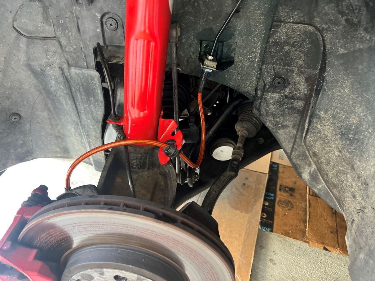 Pretty new orange stainless braided flex brake lines.