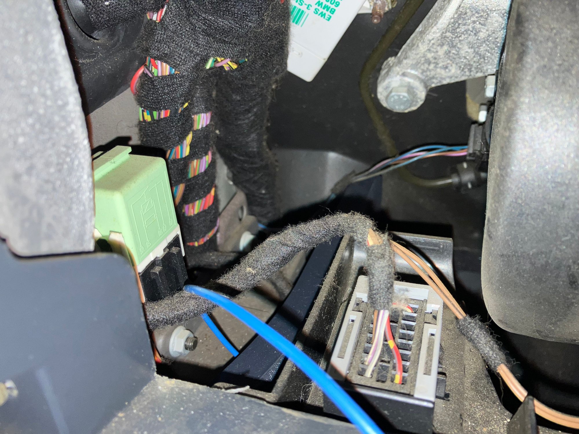 Now run the pinned wire over the top of the kick panel just above the MINIs old OBD2 port.