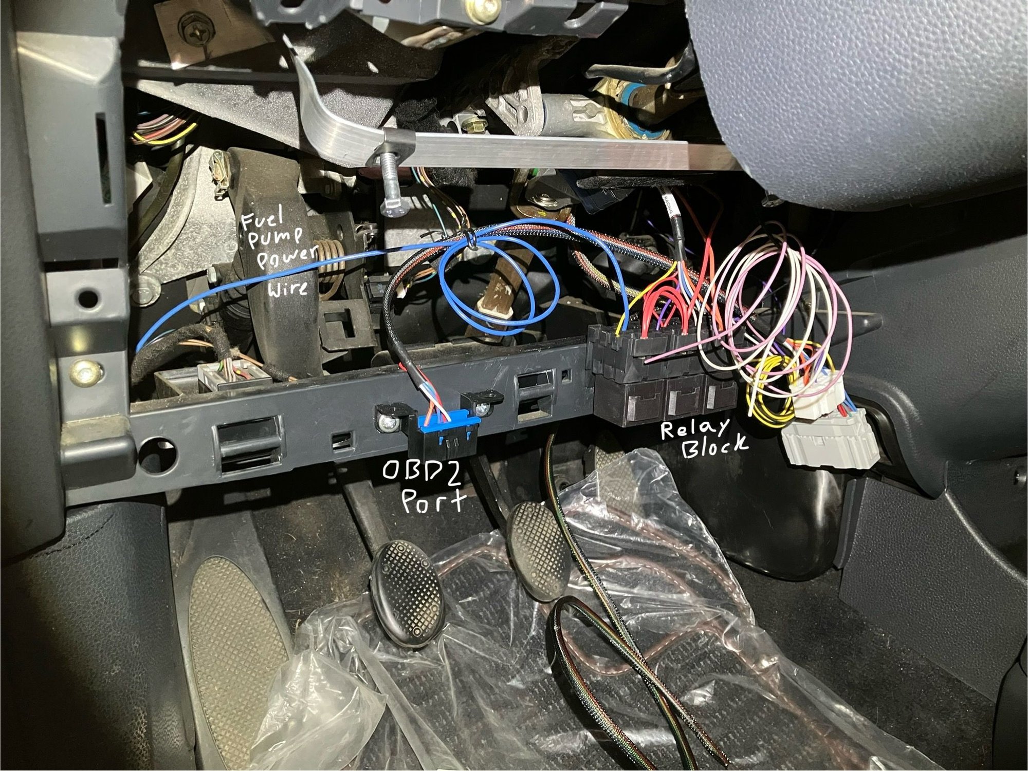 I�ve mounted the swap harness on the bar just under the steering column. If you want to keep the OEM MINI look in the interior of the car this will achieve that. You will have to trim the plastic panels but I will cover that later on. Out of all the places under the dash, mounting everything to this plastic bar seemed like the easiest and least cluttered way to do it.