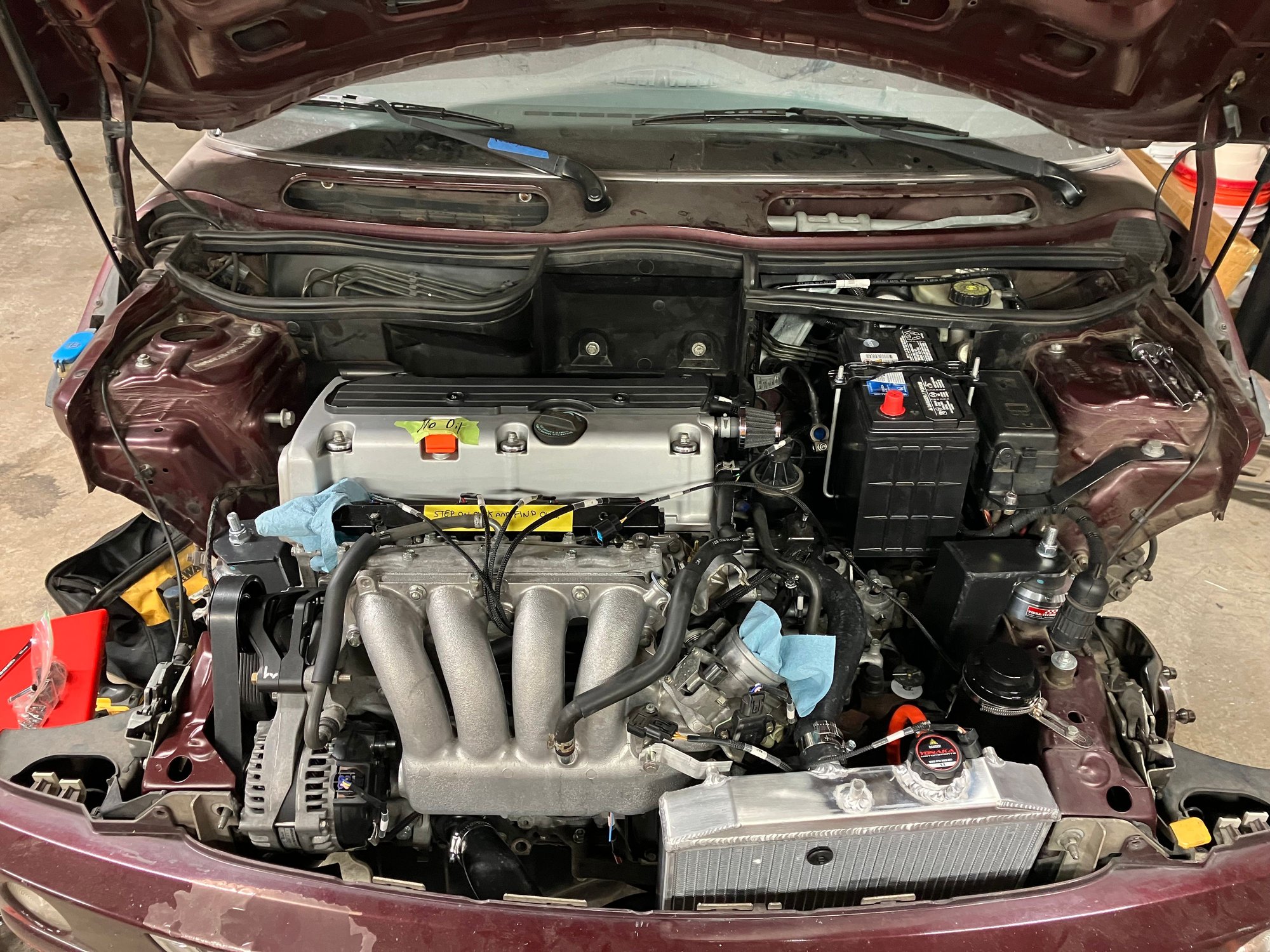The only other thing that will need to be wired is the ground trigger for the OEM MINI fan relay. From the factory the MINI ecu provides a ground signal that trips the relay when it senses the coolant get to the set temperature. We will want to imitate that with the Honda ecu. I will cover all this later on but for now this is the current state of the build. Bumper bar is on. Bumper is on. Fan is wire to the OEM plug. Lights are connected once again. It�s coming together slowly.