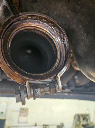 Tech tip on opening up the exhaust clamp when it's still in good shape. I used a bolt and two nuts to make a separator the spread it open and hold it open to remove the exhaust.