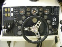 Depth gauge is behind steering wheel just under speedo.