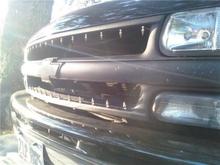 stock crome grill painted flat black and spikes installd