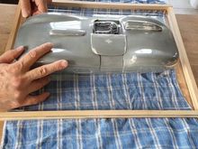 After vacuum-forming. The mold is made out of multiple pieces. The body has lots of undercuts, so the only way to get the mold out of the body is by separating and detaching front, middle and rear part.