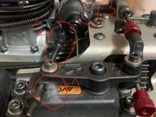 Here is another angle that might better illustrate the issue.  

#1- again, you can see the rubbing on the top of the servo with the servo horn.  

#2- look at the angle of the throttle linkage arm.  Again, I can’t change the angle of this, because I can’t rotate the carb slide set screw anymore, or it will be impeded by the center diff mount.  

#3- this is the closest I can get the set screw to the center diff mount before the diff mount prevents the carb from going out on throttle.  