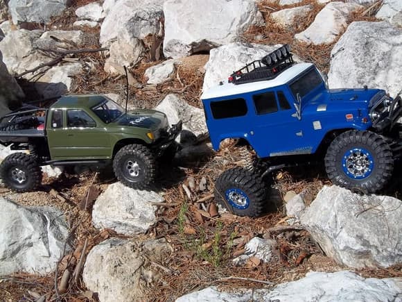 My Tamiya land cruiser and my friend's SCX-10.  I'm disgusted with myself for putting those buttons on the roof to turn the lights on/off!  I have already bought receiver controlled switches I'm just waiting for my friend to help me out with it since I'm paralyzed.