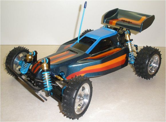 OptiMutt Custom Build: Kyosho Turbo Optima Mid SE re-engineered as a mid-motored RWD buggy

Details:

-Kyosho Turbo Optima Mid SE
-Leopard Toro 60A ESC &amp; 12T 3300kv brushless motor combo

Mods &amp; hop-ups:

-Trinity gold camber links
-Tamiya #54250 - 3x42mm aluminum tie-rods and 4.8mm ball studs &amp; ball cups throughout
-Kyosho Maxxum front control arms; GPM #2056 alloy rear arms (for Tamiya DF-02)
-Yeah Racing #M05-007D2BU - 2-degree toe-in rear hub set w/4 x 4.8mm alloy hex balls &amp; ball ends (for Tamiya M05)
-3Racing #ZX5-19/HD - 68mm CVD's (for Kyosho Lazer ZX-5)
-Yeah Racing #TA05IFS-005BU - 4-degree front C-hub set w/bearings, kingpins, spacers (for Tamiya TA05-IFS)
-3Racing #TA05-15/V2/LB - Steering blocks Ver. 2 (for Tamiya TA05); Tamiya 5x11x4mm bearings
-Yeah Racing #M03-131BU - Aluminum axles (for Tamiya M03/M04/M05 series)
-Tamiya #54235 - Alloy racing steering set w/bearings (for Tamiya FF-03)
-Yeah Racing #SER-041BU - Alloy servo mount set
-Tamiya #51000 - High-torque servo saver
-3Racing #3RAC-HTS30/LB - Short-throw Tamiya-style alloy servo horn
-Yeah Racing #M05-16/LB - Linkage set (for Tamiya M05)
-3Racing #FF03-11/LB - Front stabilizer mount kit
-Kyosho Gold shocks with custom carbon shock towers