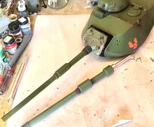 New M68 main gun barrel and recoil system installed. Note the difference in the stock barrel laying next to the turret and the new barrel. 