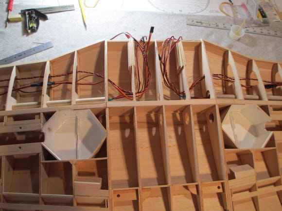 In preparation for sheeting, I had to run all of the wires in the wing.  With flaps. ailerons, retracts and navigational lights to run, the amount of wiring inside is substantial.