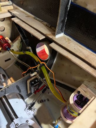 I quickly realized trying to use an oscillating saw in the front lower confines of the fuselage would be extremely difficult. So I gave up trying to run a continuous ribbon of carbon fiber below the equipment tray. Instead I made up paper templates for each of the “compartments” to make carbon fiber quilt work.  Didn’t take long to laminate in place. The triangle in front of the fuel pump I used fiberglass cloth. I’ll be moving the receivers more rearward away from the carbon fiber