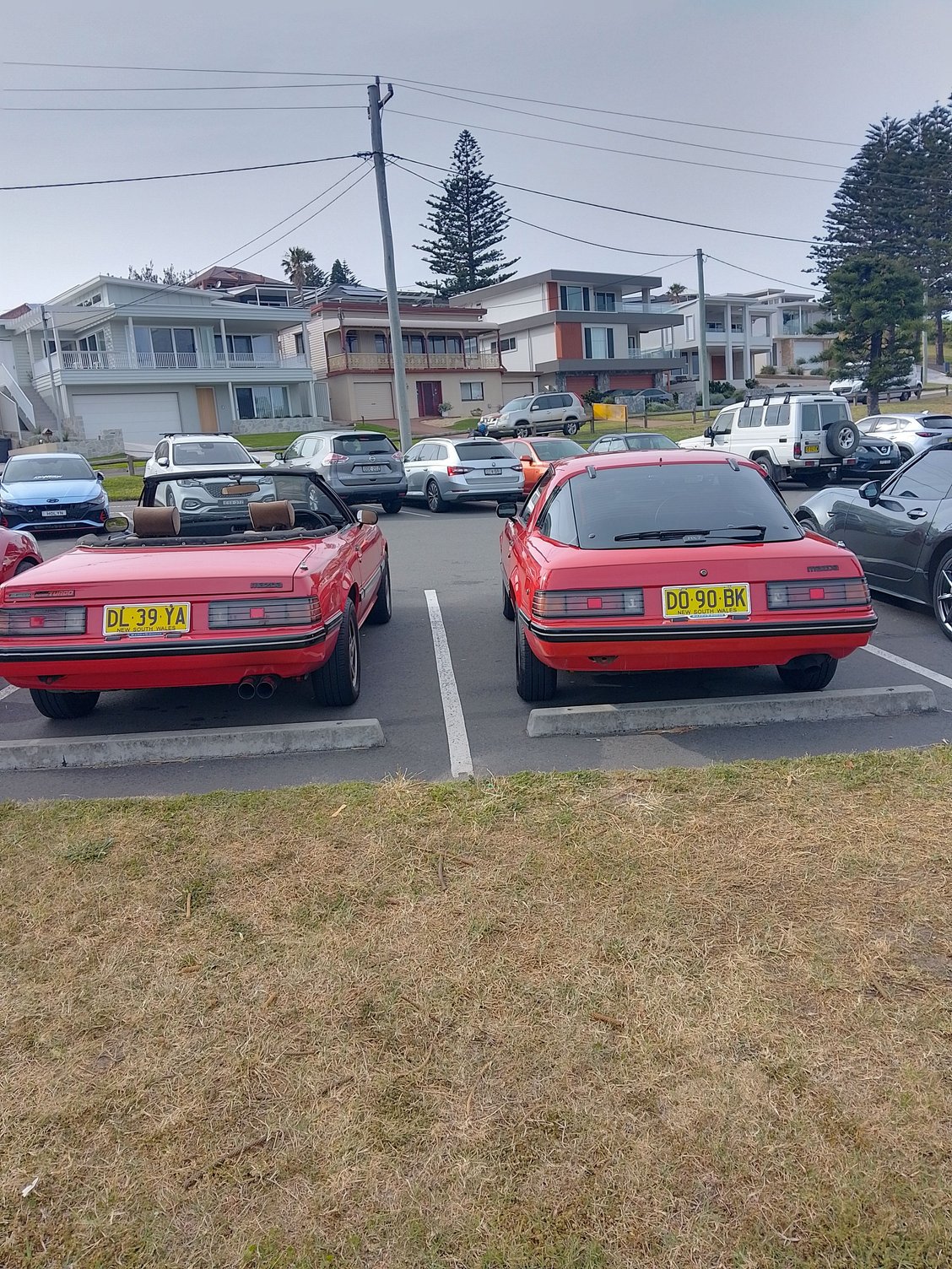 The meeting was at a beachside destination and you can see the houses in the background which enjoy splendid views.  An MX5 driver thought hed join the RX7s for a Mazda group.