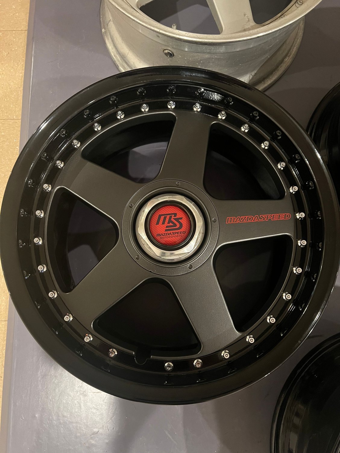 After, with black letters in the center decal, unfinished center nut 
