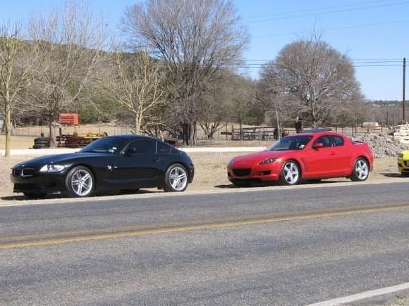 M Coupe and RX8 Side By Side.  You can see the general difference in attitude and stance of the two cars.  The 8 leans forward a bit whereas the M Coupe is sitting back on its haunches.  Both are very striking.