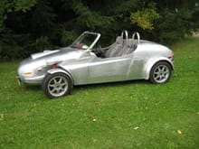 This is my handbuilt aluminum body roadster
It has a subaru 2.5 all wheel drive 5 speed
drive train with a handmade tube steel chassis
It is all street legal/emissions equipped with A/C
,cruise,antiskid(that is de-selectable).