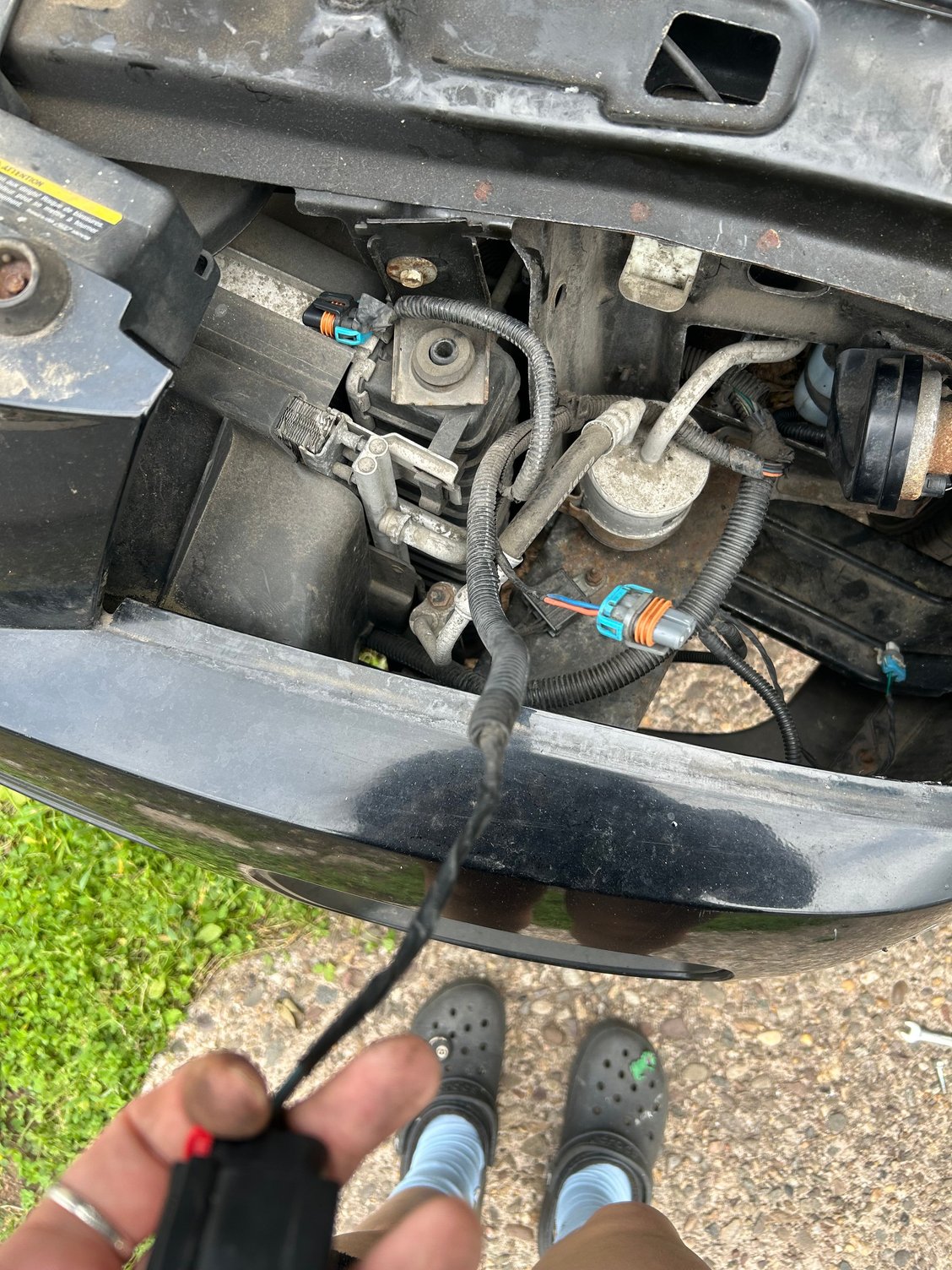 Turning signal connector in my hand and over view of headlight wiring