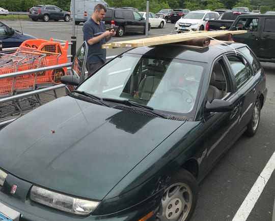 That's my 1997 SW2 showing off its makeshift roof rack comprised of rolled up and flat area rugs with rubber backing.