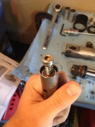 Use hex head screw to tap in the compression stacking to access the retaining ring