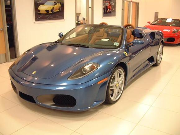 2006 F430 Spider F1; metallic blue with dark tan leather, blue piping, yellow tachometer, Daytona seats, blue piping, shields, aluminum calipers.