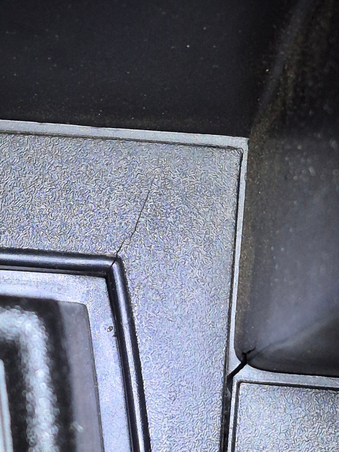 A hairline crack on the upper right corner where the cigarette lighter is