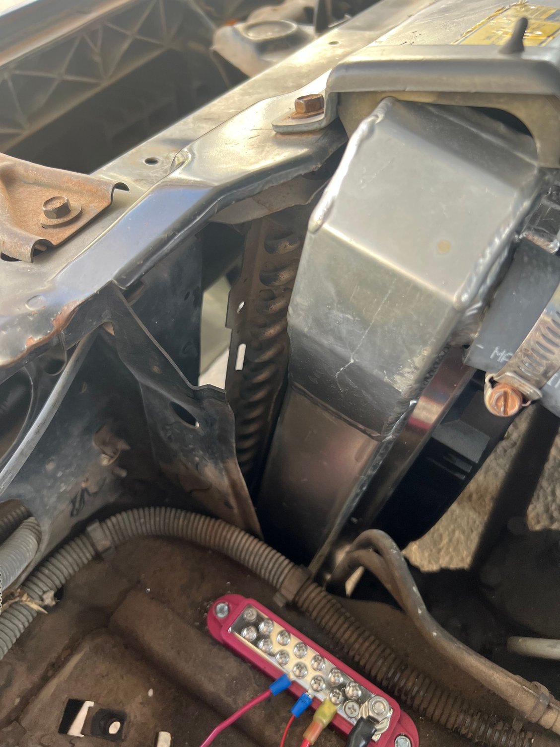 This is from inside the engine bay on the drivers side. Is there supposed to be attentional ducting here? 
