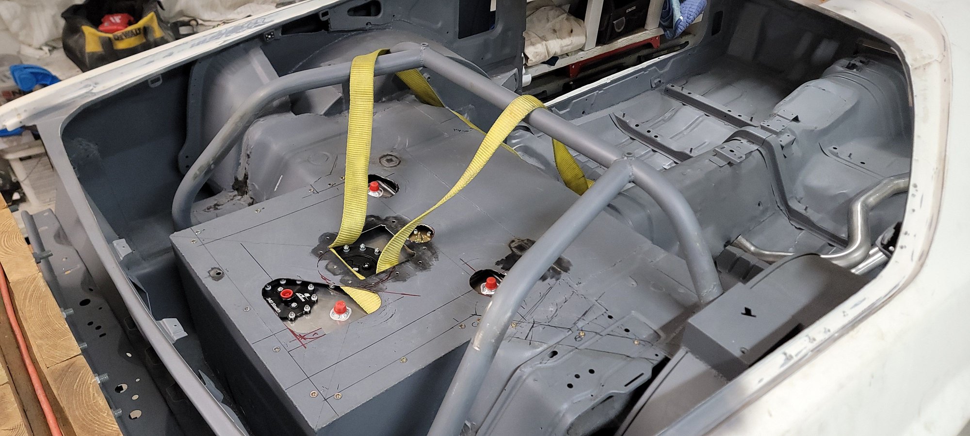 Next thing to tackle is the clearance bumps for the plumbing. Lot more design work needed here. This is just hacked up to get the cell into the car. I work alone so I was using those straps, plus a jack to pull and push the cell into place during final fitment. 