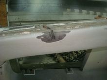 This was a tear on the lower center where one of the lower deflector mounting hardware had been ripped out.