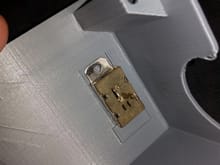 A small pocket that a commodity SPST switch is designed to snap into.