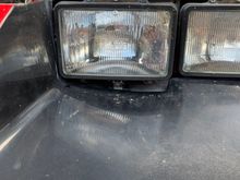 Driver side, gap underneath headlight.