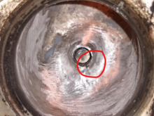 Reshaped welded port, circled is the missing bit of valve guide. This is before final finishing with tootsie rolls...