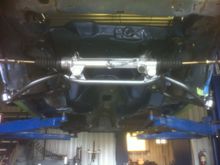 1. Re assembly begins. K member, control arms and rack are installed,