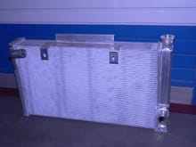 Custom fabricated radiator by Best Radiator of Hays, KS.... ( that's me ). Tabs are for oe Corvette fans & blades. Changed later to Derale fans with fabricated shrouds for more air.