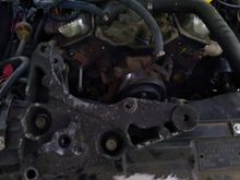Here's the front of the Vortec heads w/ Suburban bracket in foreground.  See how far apart the top left bolt hole and the stud are?