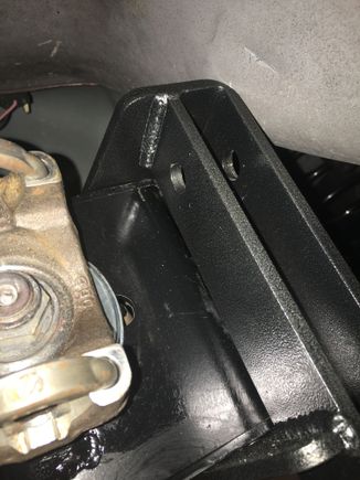 Notice the dent about an inch toward the front of vehicle.  This is from the solid arm.  The adjustable offers the second set of holes and fits a little better.