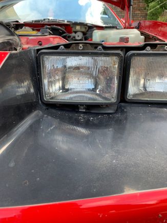 Driver side, gap underneath headlight.