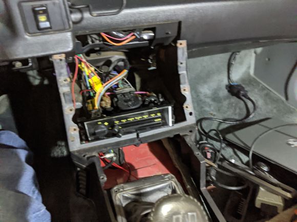 Here is what it took to get the radio to test fit on top.  Have to pull the console and remove the metal mount for the A/C.

In my opinion, this puts too much stress on the A/C controls, I do not like this option.