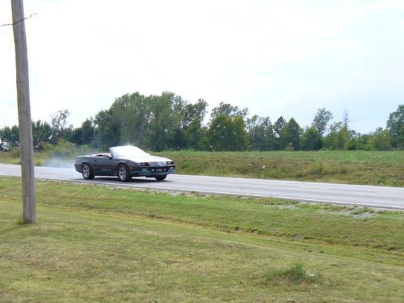 P1020545 Yeh thats smoke but its not from the motor :-) . This topless '87 runs great with its 305 TPI motor, stage 2 chip, free flow exhaust, T-5 5 Speed, and 3.08 posi. Its definately rare with the stick, and thats what makes it fun. She will out run 350 TPI, Auto Iroc's and T/A's (and of course Mustang GT's).