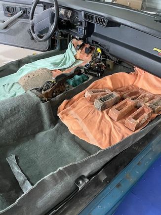 Pressed carpet under brick.  