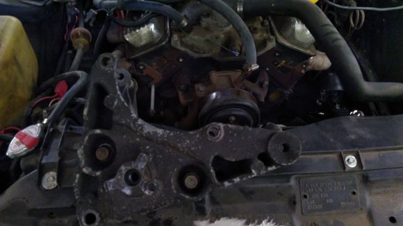 Here's the front of the Vortec heads w/ Suburban bracket in foreground.  See how far apart the top left bolt hole and the stud are?