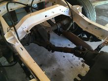 exhaust installed, and parking brake cables reattached to the frame
