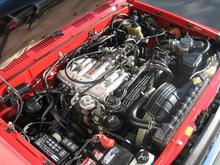 you WISH your engine was this clean!!

That's a 84-month Toyota TrueStart battery.  I can't decide to replace it with another one or get an Optima.  I've hooked up a lot of aftermarket accessories (750W power inverter, Altimeter, GPS/cell charger, etc...) so I was thinking either a yellow top or maybe even a blue top. But I'm impressed with the 84-Months out of the Toyota TrueStart so I dunno.

The power steering pump has a small leak from the back of the pump so a rebuild (or at least the rear O-ring) is an upcoming project.

Notice the 6-gauge (or is it 4?) 8ft wire attached to the positive terminal wrapped around between the fusebox and fender, through the existing hole in the passenger-side firewall, and underneath the carpet behind the dash to the center console where it is hooked to the power inverter (underneath my drivers seat) and the cheap ($5) 12V cellphone/GPS/radar detector adapter.  I had to rewire the adapter to upgrade the wiring and I wanted to be able to switch it on or off manually, regardless of whether the truck was running or not.