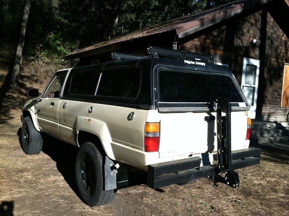 View of the bike rack collapsed for storage.  I think it looks ok actually. Utilitarian. The coopers that came on the truck were dry rotting and not safe at all. I had cooper m+s 32s from the 4runner so those are on some stock split tri spoke toyota 16s with the 1.5" wheel spacers just for now.  Searching for some 15" tires that will work for me. Fills out the wheel wells a lot better and the ride improved a lot. Off the line power suffered but that's expected with stock gearing.