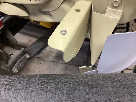 The bracket on the left was fabricated specifically for the filler strip and has a capture nut welded on the underside to facilitate ease of filler strip installation. 