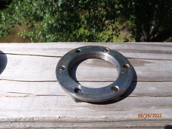 the back side of the bearing retainer nut.  this flat side rides against the outer wheel bearing (well, it touches it, they don't move relative to one another when installed)