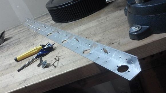 36" x 1 1/2" x 1/8" Aluminum angle. I drilled the holes (poorly) myself.