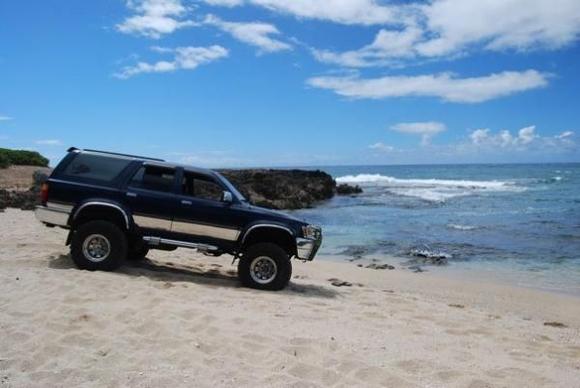 Sittin pretty in the sand - beach near the middle of the trail... BAD idea to sit in the sand, fully inflated tires...no winch or tow rope and SOFT sand...