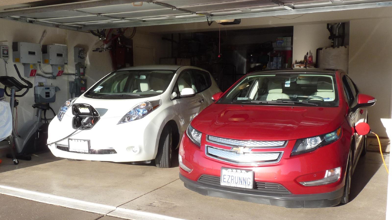 2011 Nissan Leaf and 2011 Chevy Volt, with charging station visible; photo by George Parrott