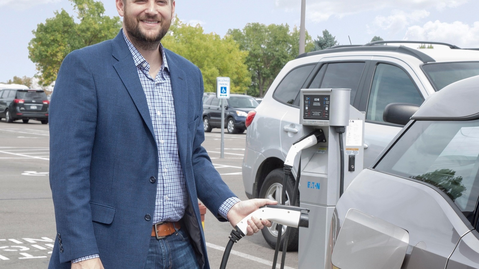 Pastor Jonathan Wiggins recharges BMW i3 electric car in Resurrection Fellowship Church parking lot