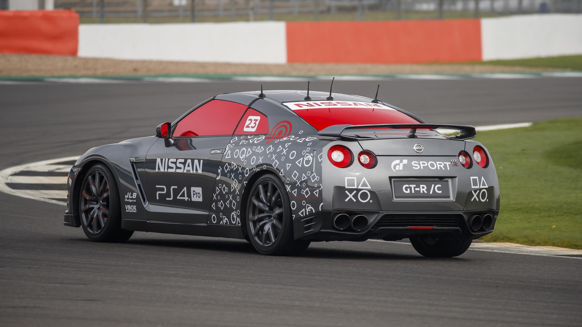Jann Mardenborough drives a Nissan GT-R around a racetrack with a video game control
