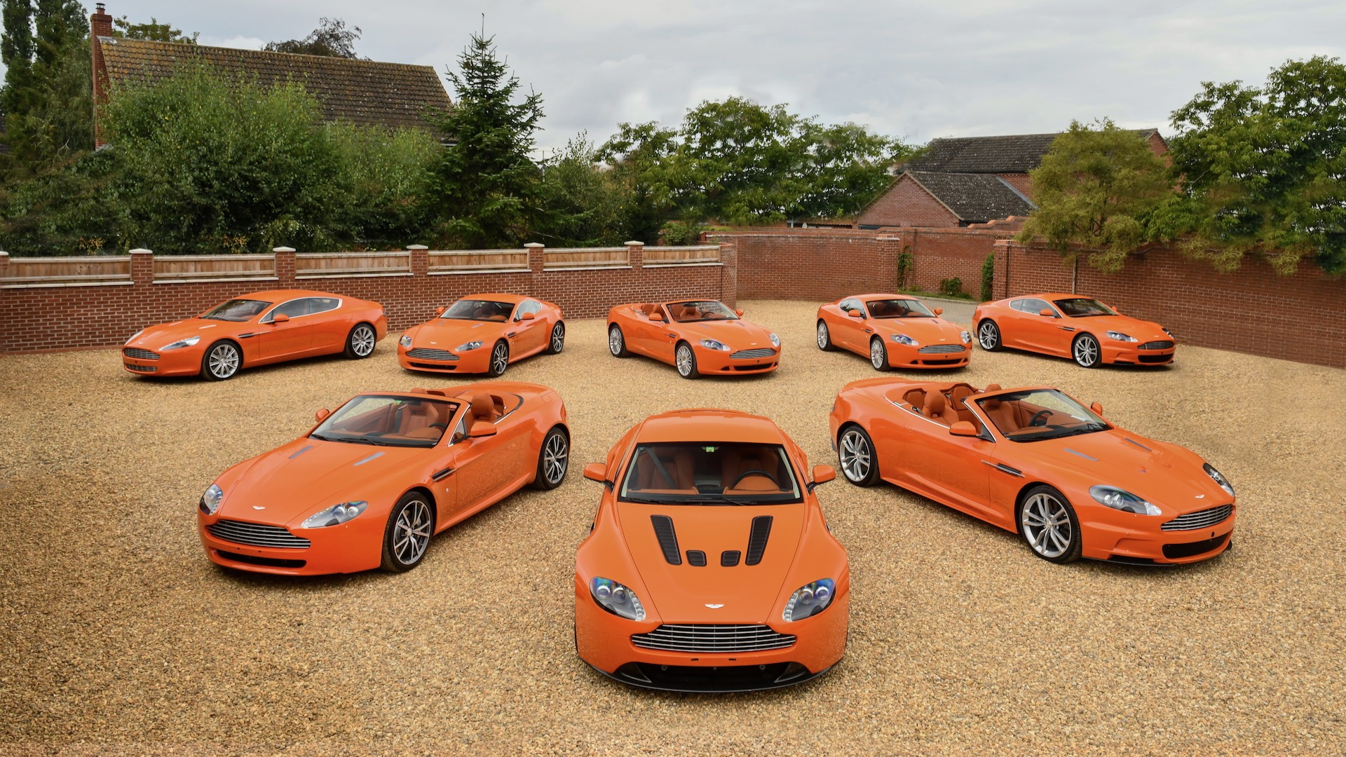 Aston Martin orange collection (photo via Bonhams)