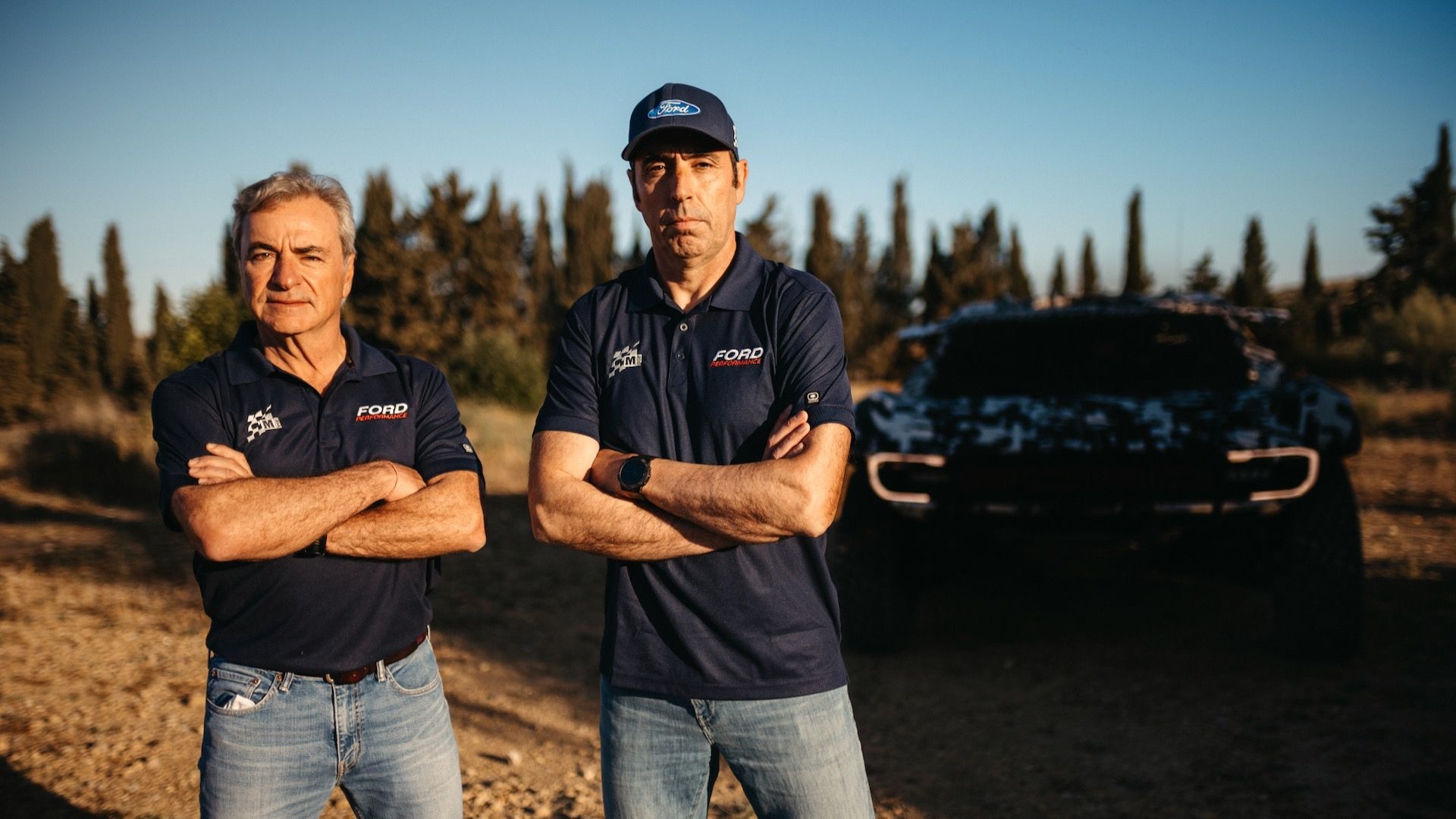 Carlos Sainz Sr. (left) and Nani Roma (right) with 2025 Dakar Rally Ford Raptor